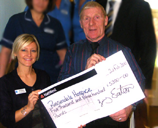Councillor Jimmy Eaton presents a cheque to Rossendale Hospice 